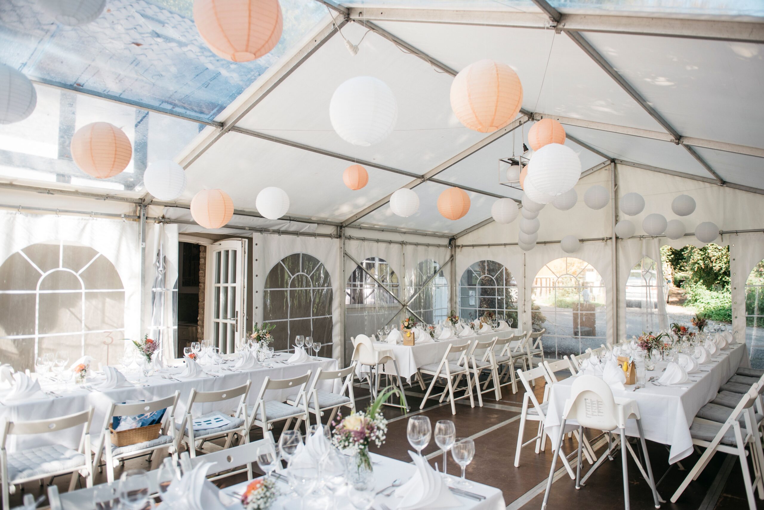 An event setup under large paper lanterns in a tent